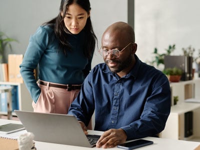 People on computer looking at finances